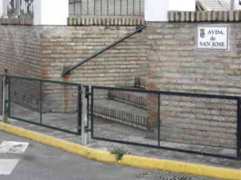 Puerta de acceso a la comunidad de vecinos de San José, con una señalización clara y un diseño funcional.