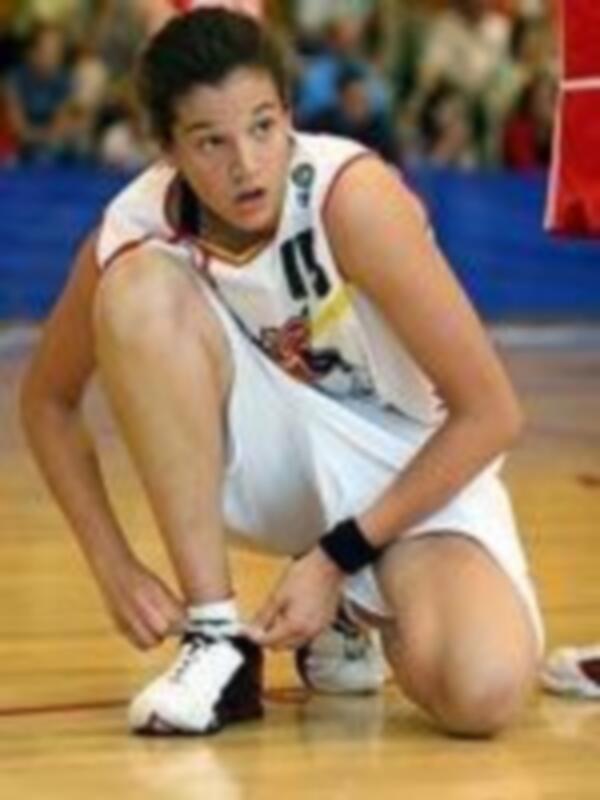 Jugador de baloncesto ajustando su atuendo durante un partido.