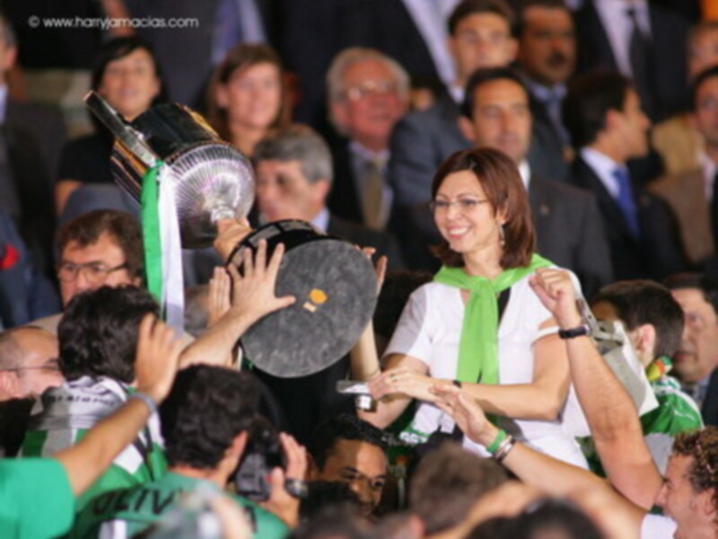 Celebración con la Copa del Rey en el estadio, rodeada de aficionados y periodistas.