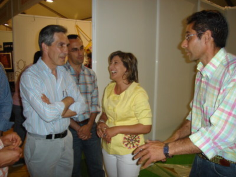 Una reunión de trabajo en un espacio de oficina, con personas conversando y sonriendo.