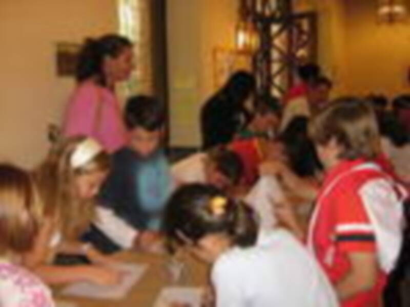 Una escuela primaria con estudiantes sentados en sus mesas, con un profesor en el fondo. La imagen muestra una escena de aprendizaje y educación en un entorno escolar.