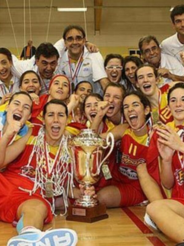 Equipo de baloncesto celebrando su victoria con un trofeo, todos sonrientes y emocionados.