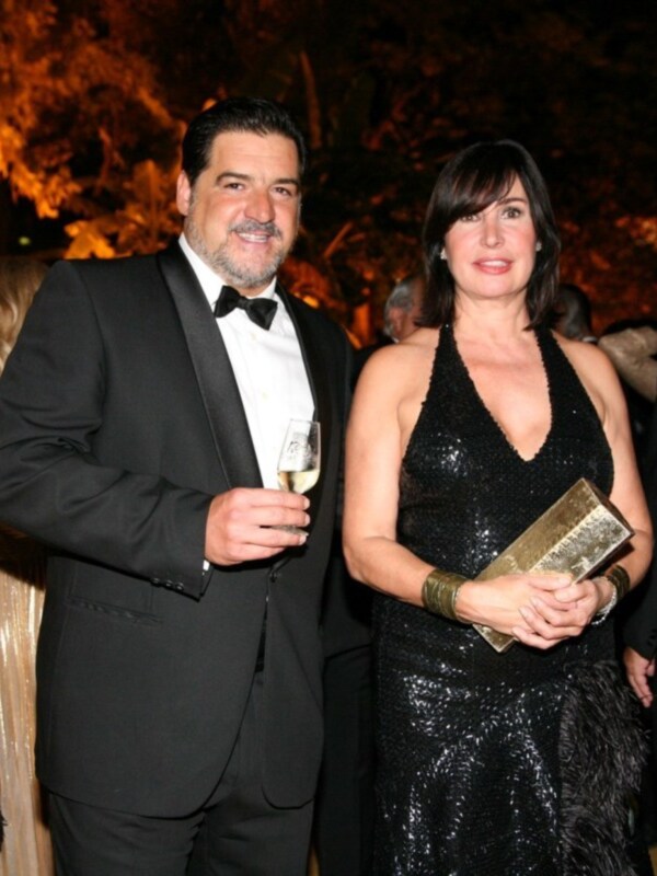 Elegant couple dressed in formal attire at a sophisticated event.