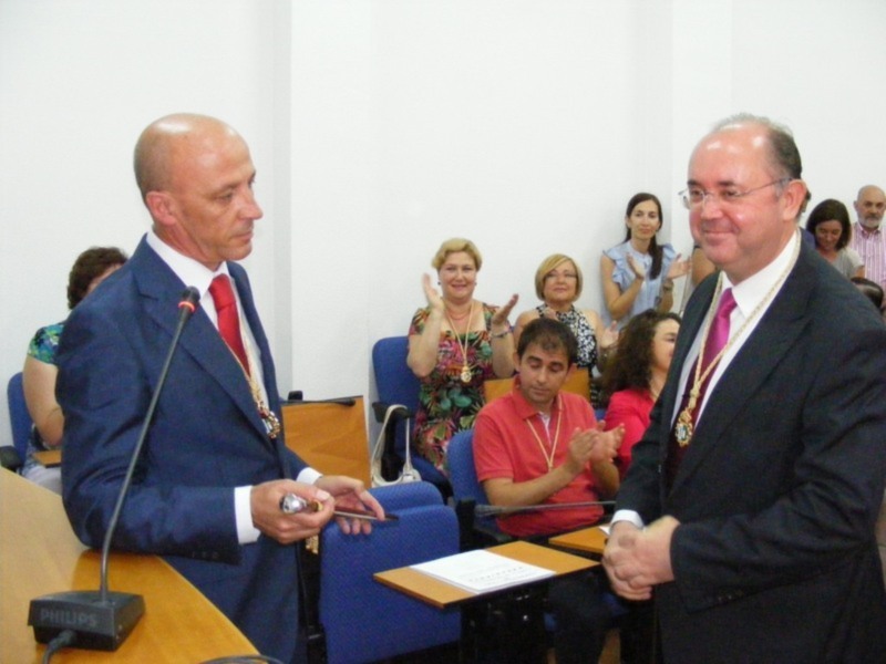 Celebración de un evento oficial en una sala de conferencias, con asistentes aplaudiendo.
