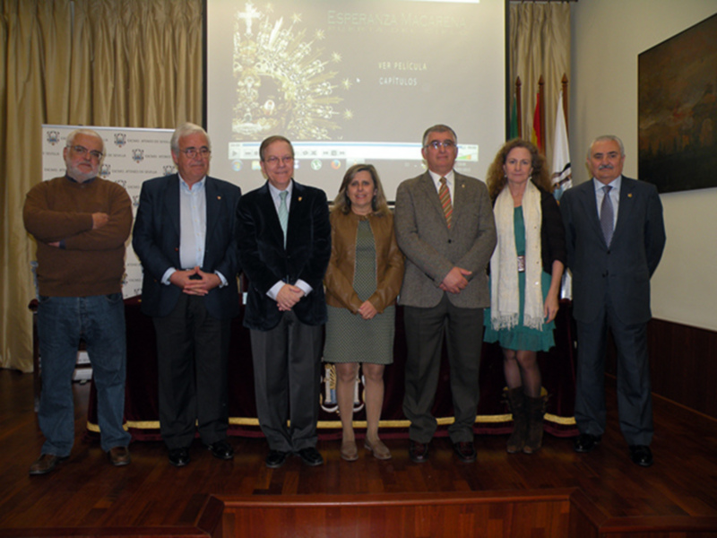 Grupo de personas posando frente a un panel informativo con una imagen de la ciudad de Carthagines.