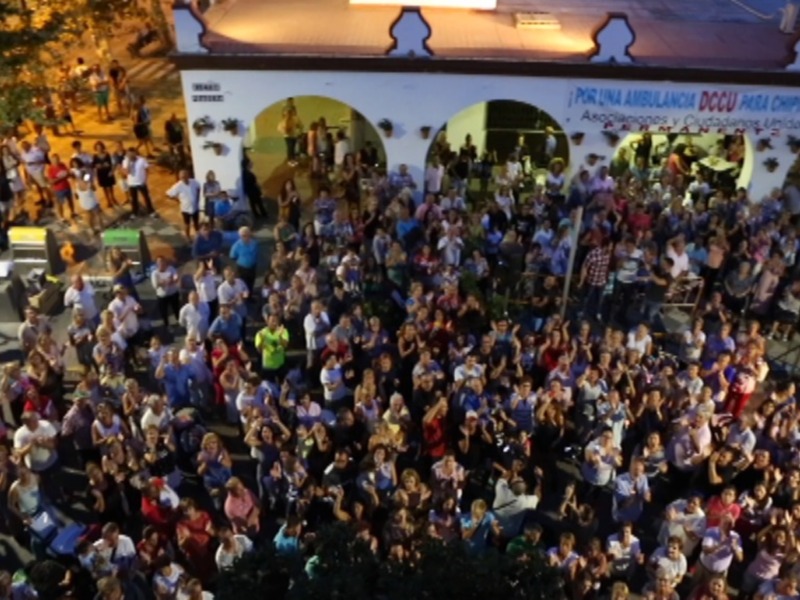 Gran concurrencia en un evento al aire libre, con una gran cantidad de personas reunidas y celebrando.