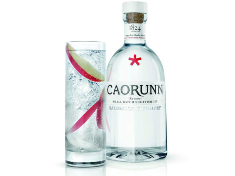 Botella y vaso de Caorunn Gin, destilado artesanal escocés de pequeña lote.