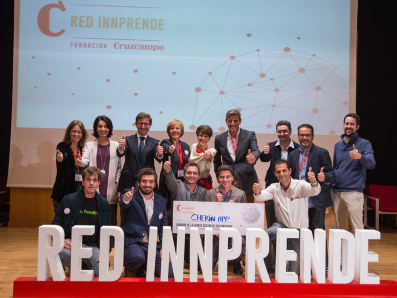 Equipo de la Red Innprende de la Fundación Cruzcampo posa junto a su logotipo y el mensaje 'Chekin App'.