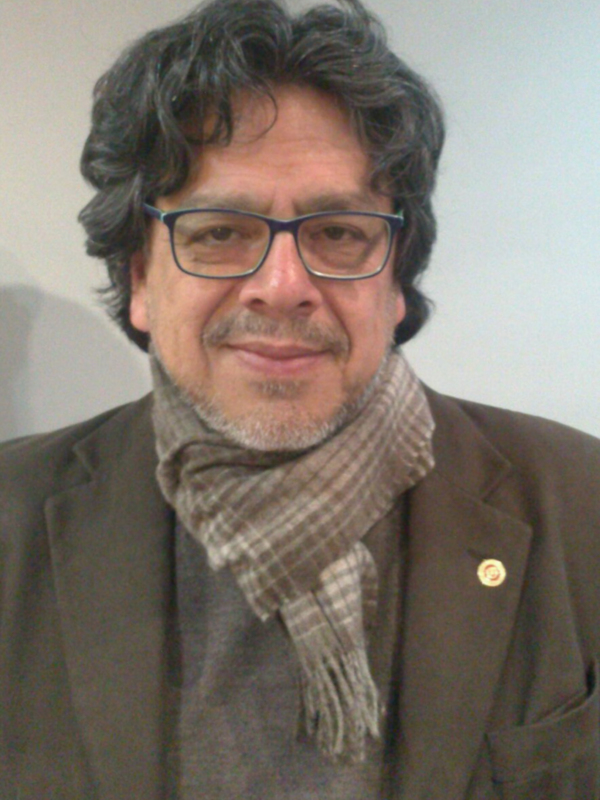Portrait of a person wearing glasses and a scarf.