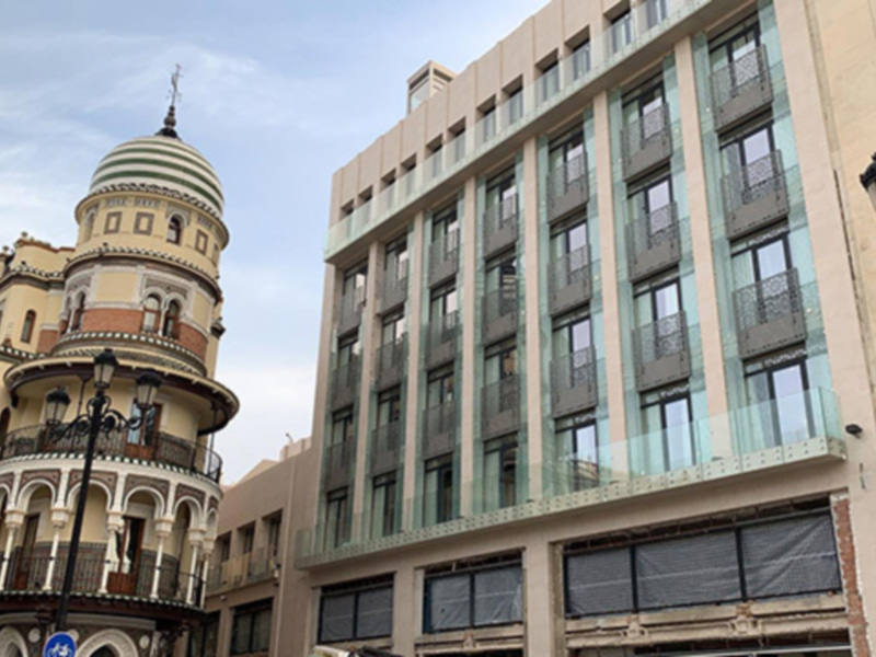 Edificios históricos y modernos en una ciudad, destacando arquitectura variada en el centro urbano.