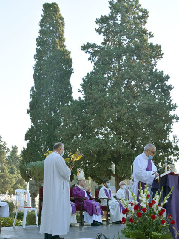 Eucaristía en un entorno al aire libre rodeado de árboles y flores, con sacerdotes en trajes litúrgicos y un ambiente sereno.