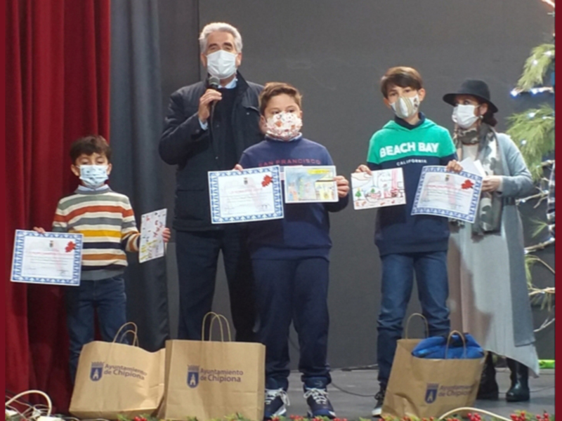 Premiación de dibujos navideños en Chipiona. Niños felices recibiendo sus certificados y regalos.