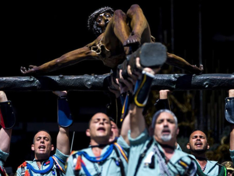 Actores levantan una estatua de Cristo en una representación dramática religiosa.