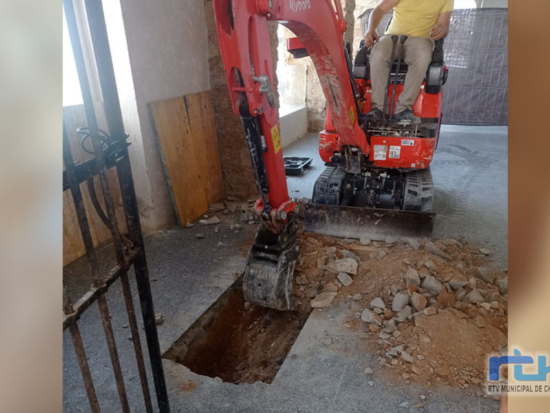 Excavación de suelo con una miniexcavadora en una obra de construcción.