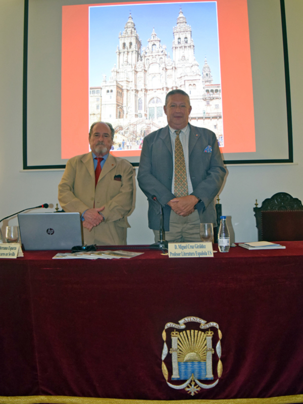 Dos hombres en trajes frente a una proyección de la Catedral de Santiago de Compostela.