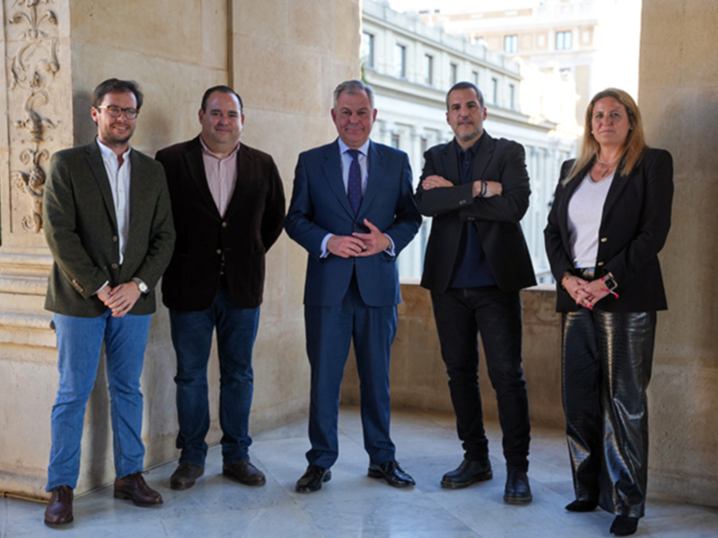 Grupo de profesionales posando en un patio clásico.
