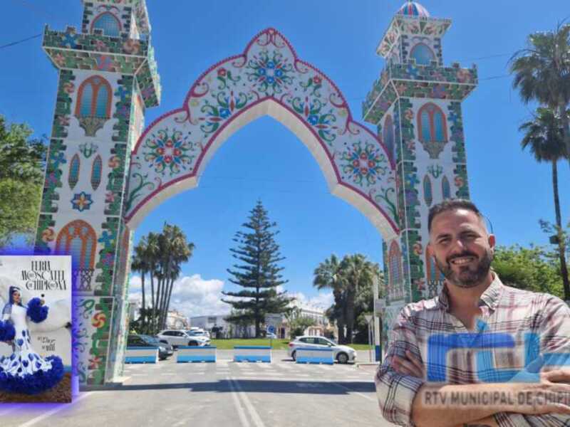 Persona sonriendo frente a un arco decorativo con mosaicos coloridos y palmeras al fondo en Chipiona, España.